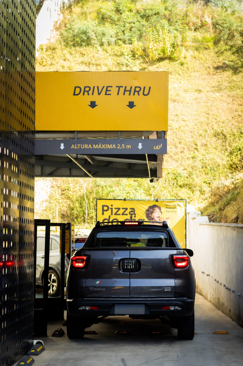 Carro entrando no drive-thru da Pizza Thruu